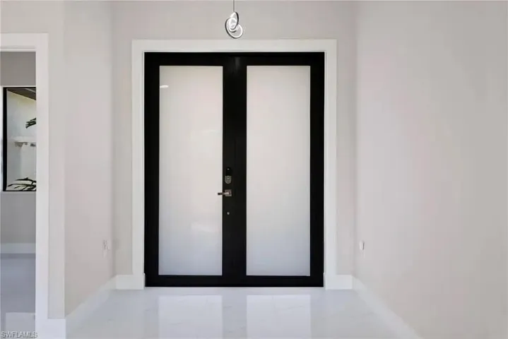Entryway with french doors and light marble finish flooring