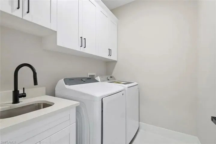 Laundry area featuring cabinet space and washing machine and clothes dryer
