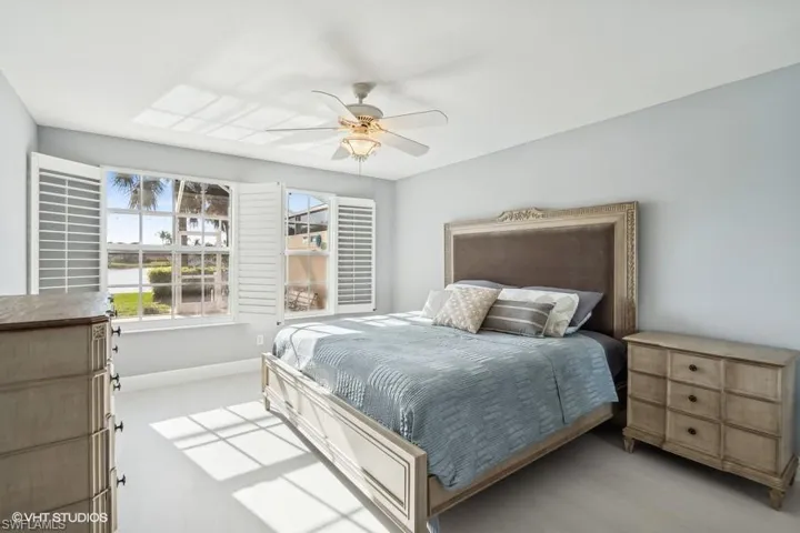 Carpeted bedroom with ceiling fan