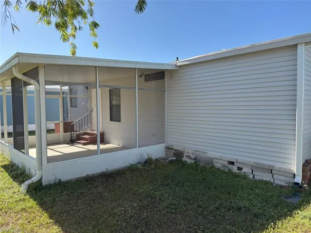Rear view of house with a yard