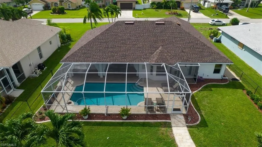 Overhead view of pool and screen cage and paver walk to boat dock.