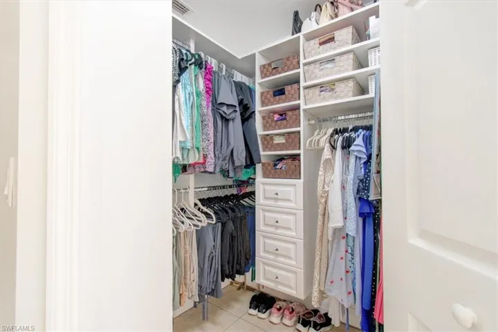 Spacious closet featuring light tile patterned flooring