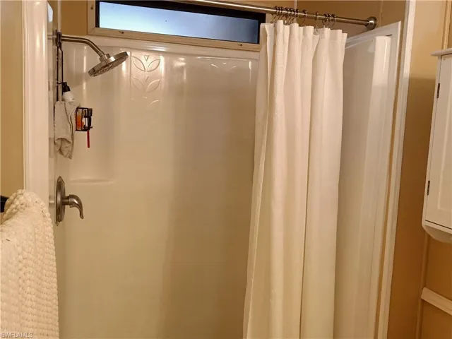Full bathroom featuring a shower with curtain