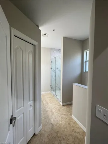 Hall featuring visible vents and baseboards