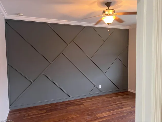 Spare room with a ceiling fan and wood finished floors