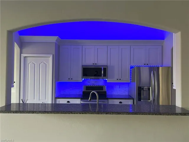 Kitchen featuring backsplash and stainless steel appliances