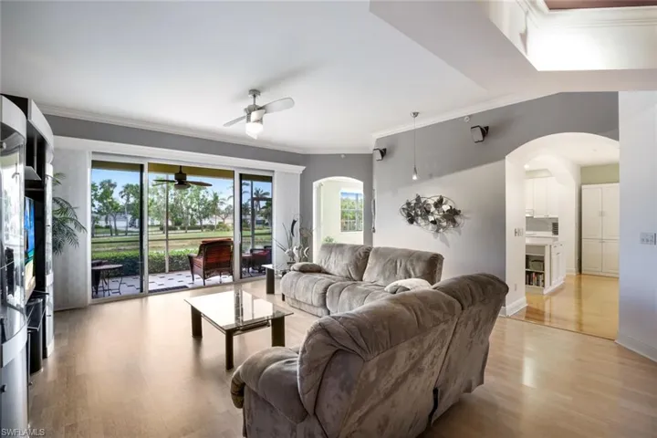 Great room has large sliding doors with access to screened lanai & view of the lake.