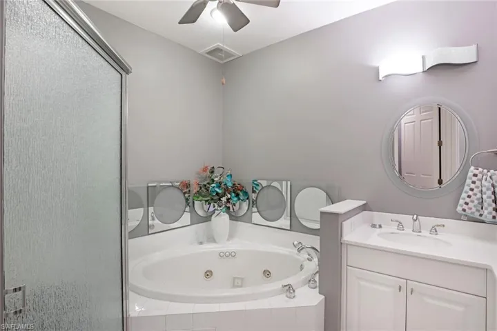 Primary bathroom with walk-in shower and jetted tub.