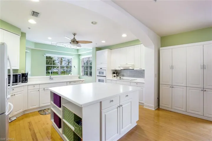 Spacious, bright kitchen with large island and lots of cabinets.