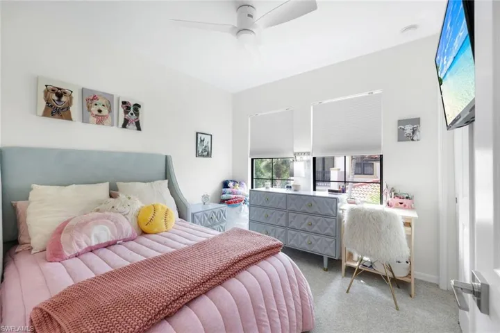 Bedroom with light carpet and ceiling fan