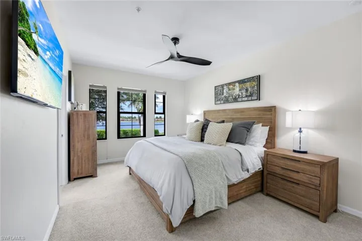 Bedroom with light carpet and ceiling fan