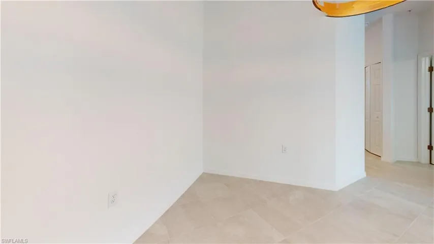 Empty room with light tile patterned floors