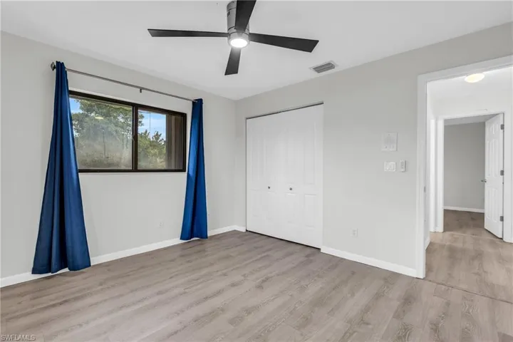 Unfurnished bedroom with a closet, ceiling fan, and hardwood / wood-style floors