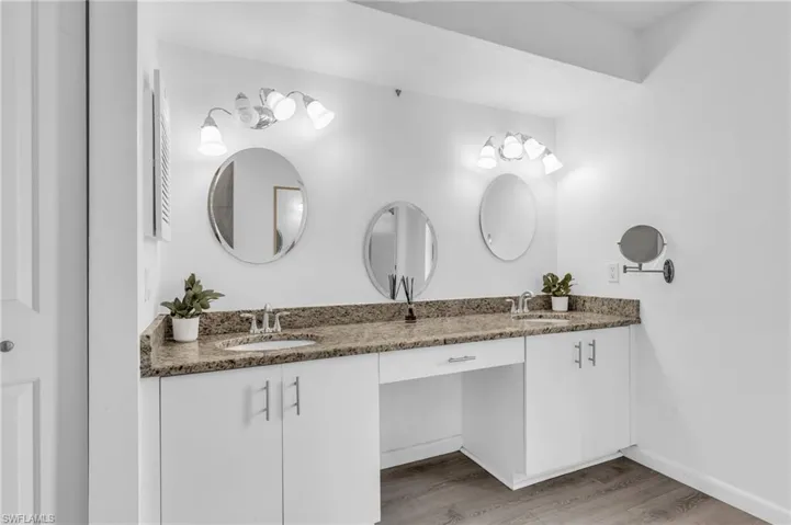 Bathroom with hardwood / wood-style floors and double vanity