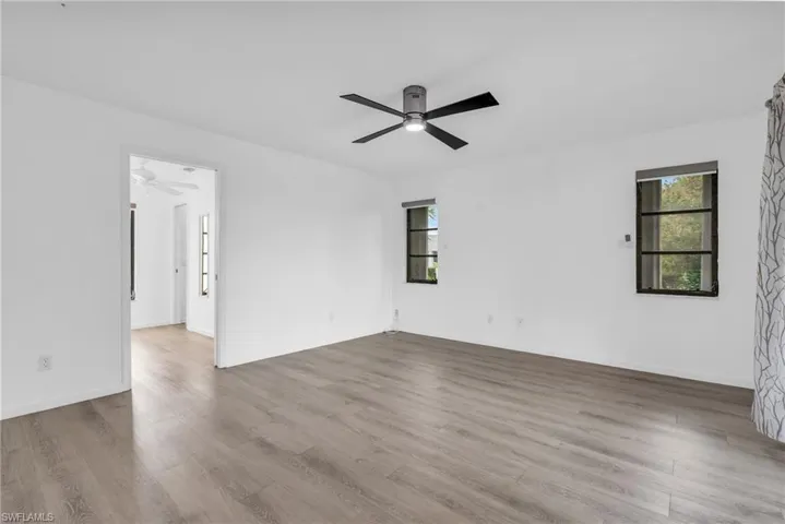Spare room featuring ceiling fan and light wood-type flooring