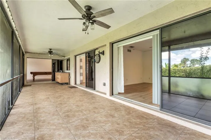 Unfurnished sunroom with ceiling fan and billiards