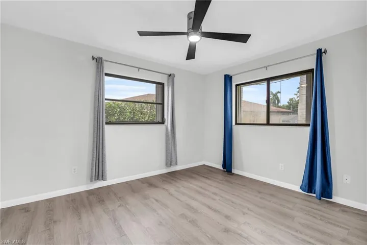 Empty room featuring ceiling fan and light wood-type flooring
