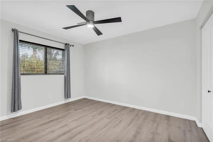 Spare room with light hardwood / wood-style floors and ceiling fan