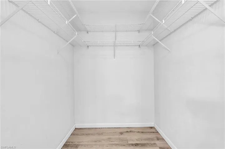 Spacious closet featuring hardwood / wood-style floors
