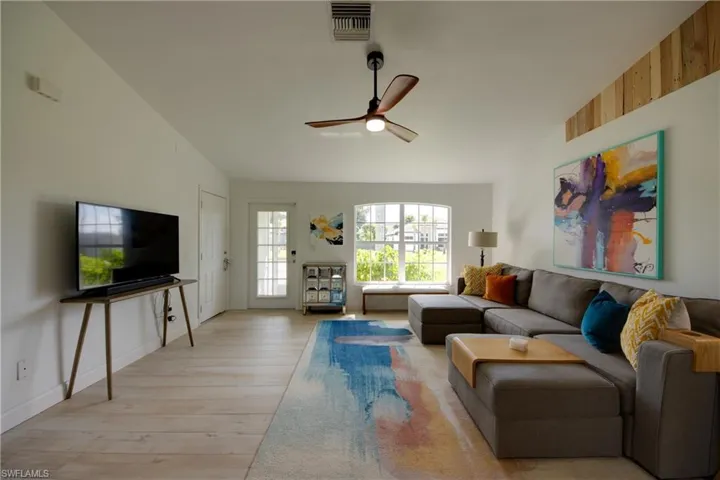 Living room featuring high ceilings and modern fan