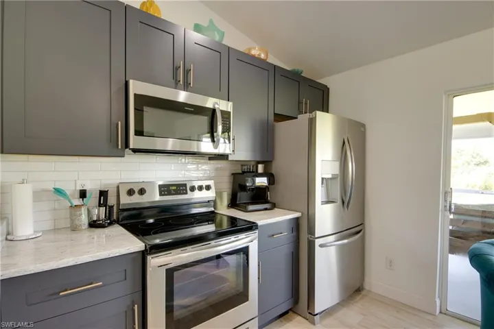 Kitchen featuring custom tile backsplash