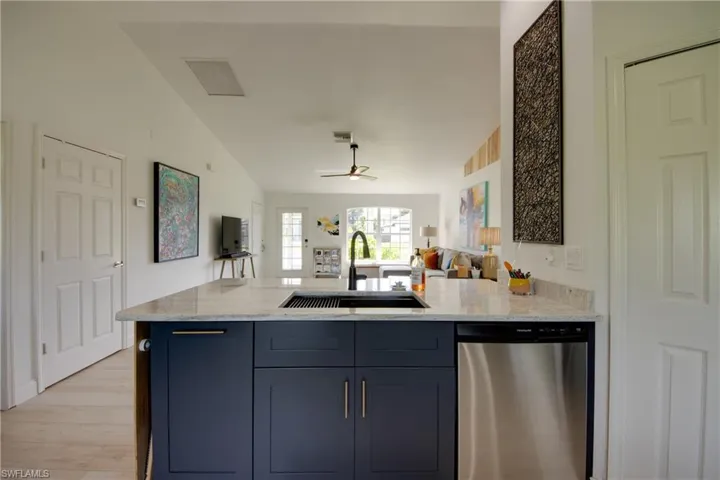 Kitchen featuring custom cabinets new sink and faucet with a stainless steel dishwasher