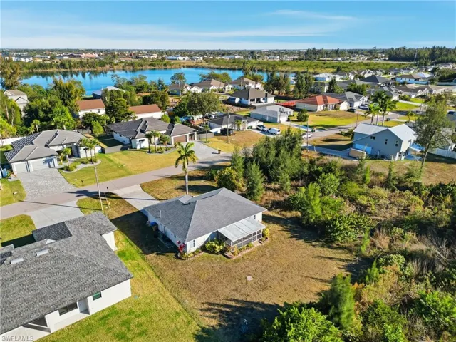 Aerial perspective of suburban area with a large body of water