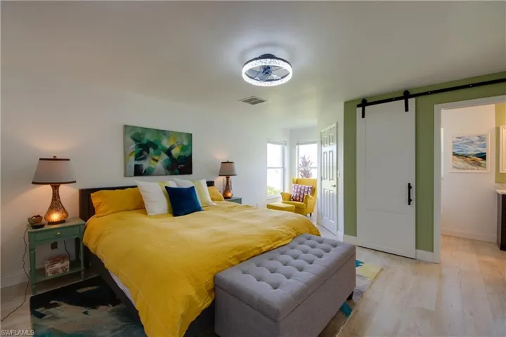 Bedroom with a barn door to bathroom