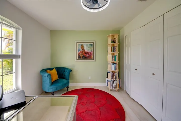 Guest room with plenty of natural light, ceiling fan, wood-style tile flooring
