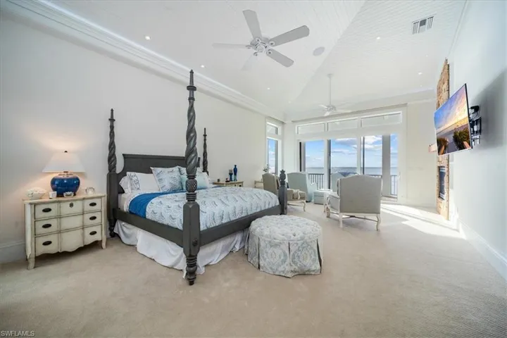 Bedroom with crown molding, high vaulted ceiling, wood ceiling, and ceiling fan.