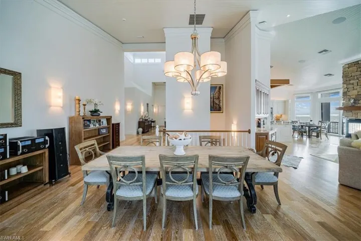 Dining area with crown molding, a chandelier, and light hardwood / wood-style floors