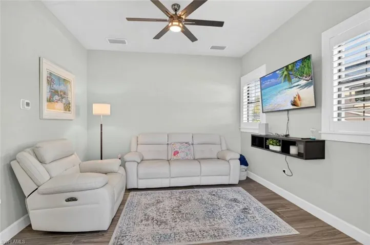 Living room with wood finish floors and ceiling fan