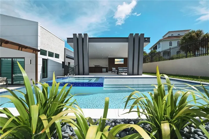 View of pool featuring a patio and a pool with connected hot tub