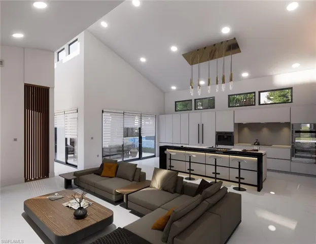 Living area featuring high vaulted ceiling and recessed lighting