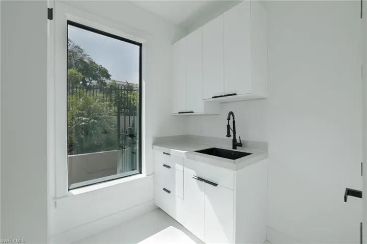 Bar with white cabinets and modern cabinets