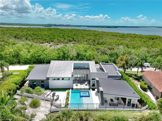 View from above of property featuring a forest and a pool area