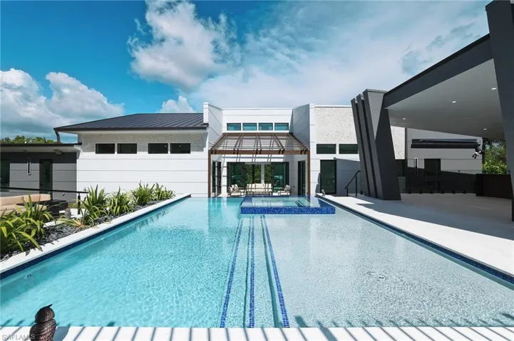 View of swimming pool featuring a pool with connected hot tub and a patio area