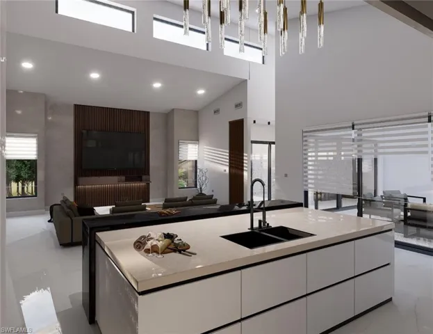 Kitchen featuring a sink, light marble finish floors, white cabinets, modern cabinets, and a towering ceiling