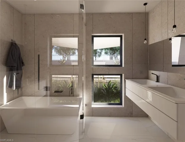 Bathroom featuring a soaking tub, marble look tile flooring, and double vanity