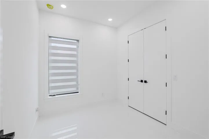 Hallway with baseboards and recessed lighting