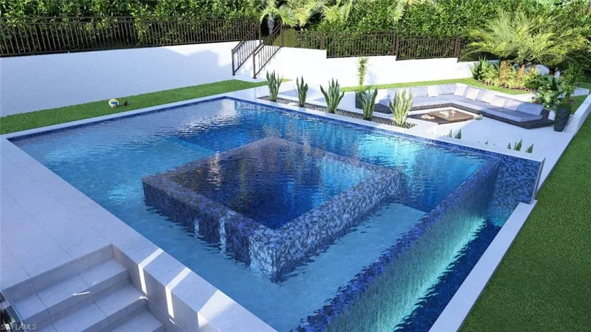 View of pool with a hot tub and a fenced backyard