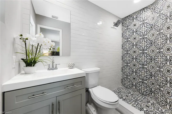 The Primary Bath has a New Vanity with Solid Top, a Subway Tiled Wall, Designer Tiled Shower, etc.
