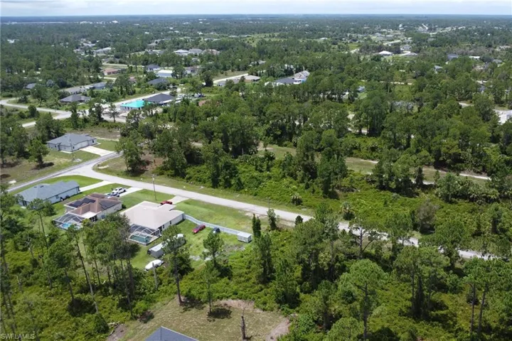 Aerial view of property's location with a forest