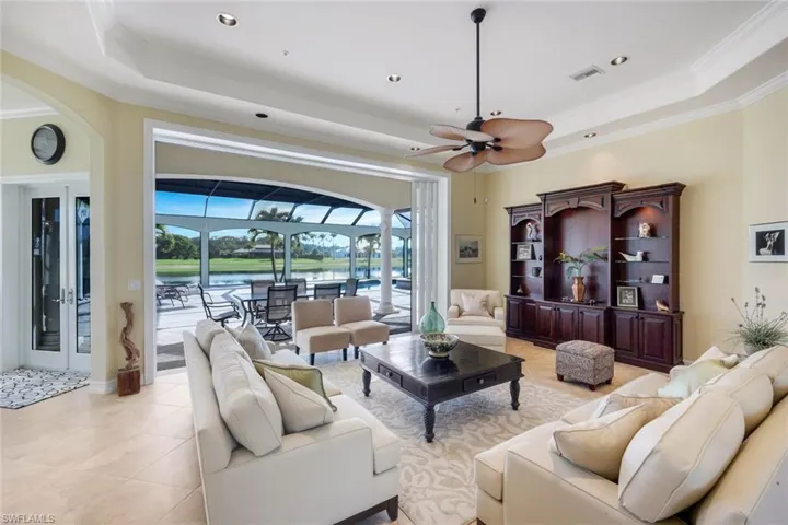 Recessed lighting, ceiling fan, built-in entertainment center, tile flooring, and a screened patio with a pool