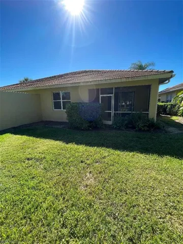 Back of house with a lawn