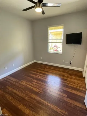 Unfurnished room with flooring / wood-style floors and ceiling fan