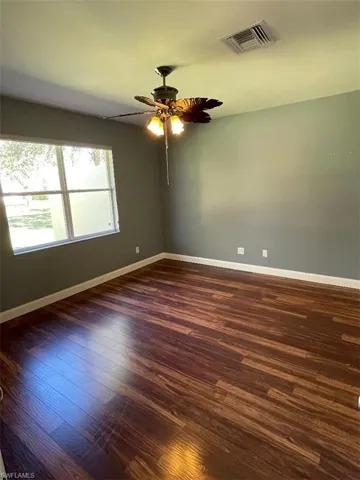 Master bedroom with ceiling fan and flooring
