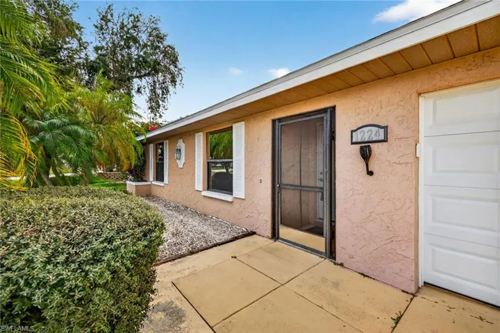 Property entrance featuring stucco siding