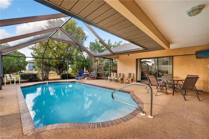 Swimming pool featuring a patio area, a screencage, a lanai, and outdoor dining area