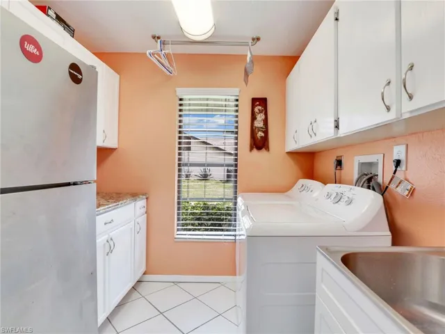 Laundry room with lots of cabinets.  Washeer, dryer, and refrigerator included